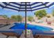 Inviting pool area with lounge chairs, striped umbrella, and outdoor seating offering a relaxing retreat at 14806 E Crested Crown --, Fountain Hills, AZ 85268