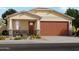 Charming one-story home with a two-car garage, stone accents and low maintenance desert landscaping at 15940 W Gray Fox Trl, Surprise, AZ 85387