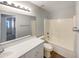 Well-maintained bathroom features a single sink vanity, a large mirror, and shower-tub combination at 1595 S 227Th Ave, Buckeye, AZ 85326