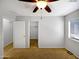 Comfortable bedroom with a ceiling fan, a closet, and natural light through a large window at 1595 S 227Th Ave, Buckeye, AZ 85326