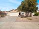 Charming single-story home with a well-maintained front yard and a two car garage at 1595 S 227Th Ave, Buckeye, AZ 85326