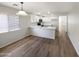 Modern kitchen with white cabinets, quartz countertops, and stainless steel appliances at 1595 S 227Th Ave, Buckeye, AZ 85326