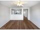 Bright living room featuring wood-look floors and a view into the modern, updated kitchen at 1595 S 227Th Ave, Buckeye, AZ 85326