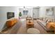 Bright living room with modern furniture, neutral tones, and stylish wood flooring at 1595 S 227Th Ave, Buckeye, AZ 85326
