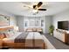 Inviting primary bedroom featuring a bay window, ceiling fan, and warm, neutral decor at 1595 S 227Th Ave, Buckeye, AZ 85326