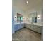 Bathroom featuring dual sinks, custom cabinets, and modern lighting fixtures at 1650 W Lucky Ln, Queen Creek, AZ 85144