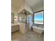 Modern bathroom with a frameless shower, soaking tub and view window at 1650 W Lucky Ln, Queen Creek, AZ 85144