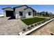 Charming home featuring a manicured front yard with stone pavers and modern architectural design at 1650 W Lucky Ln, Queen Creek, AZ 85144