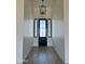 Front entry hallway with decorative lighting and modern front door at 1650 W Lucky Ln, Queen Creek, AZ 85144