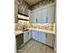 An auxiliary kitchen area with custom cabinetry, a modern sink and stainless steel dishwasher at 1650 W Lucky Ln, Queen Creek, AZ 85144