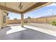 Covered patio and backyard with stone landscaping and partial artificial turf, perfect for outdoor enjoyment at 16762 W Sonora St, Goodyear, AZ 85338