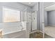 Bathroom with soaking tub and a glass-enclosed shower, combining relaxation and modern convenience at 16762 W Sonora St, Goodyear, AZ 85338