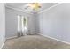 Bedroom with carpet, neutral walls, ceiling fan, and a bright window at 16762 W Sonora St, Goodyear, AZ 85338