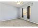 Bedroom with neutral walls, carpet, ceiling fan, and window with dark curtains at 16762 W Sonora St, Goodyear, AZ 85338