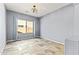 Versatile flex space with tile flooring, neutral paint, and a large window at 16762 W Sonora St, Goodyear, AZ 85338