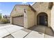 Close up of a charming single-story home with a two-car garage and a decorative front door at 16762 W Sonora St, Goodyear, AZ 85338