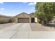 Charming single-story home with a two-car garage and a well-maintained landscaped front yard at 16762 W Sonora St, Goodyear, AZ 85338