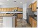 Well-appointed kitchen with wood cabinets, granite countertops, and stainless steel appliances at 16762 W Sonora St, Goodyear, AZ 85338