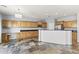 Spacious kitchen with wood cabinetry, granite counters, stainless steel appliances, and unique flooring at 16762 W Sonora St, Goodyear, AZ 85338