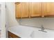 Handy utility sink with upper cabinets adding convenience and storage capacity to the space at 16762 W Sonora St, Goodyear, AZ 85338