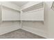 Walk-in closet featuring ample shelving and rod space, optimizing organization and storage capabilities at 16762 W Sonora St, Goodyear, AZ 85338