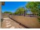 Enclosed backyard featuring a view through decorative black iron fencing at 16821 S 23Rd St, Phoenix, AZ 85048