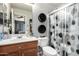 Cozy bathroom featuring a vanity with ample counter space, a toilet, and a shower with a decorative curtain at 16821 S 23Rd St, Phoenix, AZ 85048
