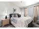 Bedroom with neutral gray walls and carpet with a queen bed and decorative pillows at 16821 S 23Rd St, Phoenix, AZ 85048