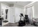Functional bedroom featuring a stationary bike, sliding door closet, and open doorway at 16821 S 23Rd St, Phoenix, AZ 85048