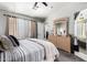 Bedroom with carpet, neutral walls, ceiling fan, and access to ensuite bathroom at 16821 S 23Rd St, Phoenix, AZ 85048