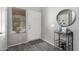Well-lit foyer with tile flooring, showcasing a decorative mirror and adjacent window at 16821 S 23Rd St, Phoenix, AZ 85048