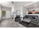 Open-concept living room with a cozy seating area and elegant wood-look flooring at 16821 S 23Rd St, Phoenix, AZ 85048