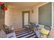 Charming covered patio with comfortable seating and a black and white striped rug at 16821 S 23Rd St, Phoenix, AZ 85048