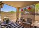Cozy covered patio with comfortable seating, decorative pillows, and a privacy screen at 16821 S 23Rd St, Phoenix, AZ 85048