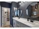 Modern bathroom with double vanity, sleek mirrors, and brick accent wall at 1694 E Dogwood Ln, Gilbert, AZ 85295