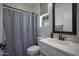 Bright bathroom featuring a vanity, toilet, and shower with a stylish gray curtain at 1694 E Dogwood Ln, Gilbert, AZ 85295