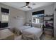 Inviting bedroom with twin beds, neutral decor, and a ceiling fan for added comfort at 1694 E Dogwood Ln, Gilbert, AZ 85295