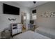 Spacious bedroom featuring twin beds, a TV, and an attached ensuite bathroom at 1694 E Dogwood Ln, Gilbert, AZ 85295