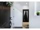 Elegant entryway featuring a dark wood door, a decorative wreath, and a sleek mirror at 1694 E Dogwood Ln, Gilbert, AZ 85295