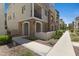 Stunning exterior of a multi-story home with stone accents and a private balcony, beautifully landscaped with a sidewalk at 1694 E Dogwood Ln, Gilbert, AZ 85295