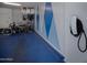 Well-organized garage with an electric car charging station and a neatly painted accent wall at 1694 E Dogwood Ln, Gilbert, AZ 85295