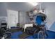 Clean garage with ample storage, a painted accent wall, and multiple bikes and equipment stored at 1694 E Dogwood Ln, Gilbert, AZ 85295