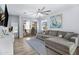 Cozy living room featuring a comfortable gray sectional sofa, stylish ceiling fan, and a glass slider to a balcony at 1694 E Dogwood Ln, Gilbert, AZ 85295