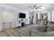 Spacious living room with a large sectional sofa, modern ceiling fan, and access to an outdoor balcony at 1694 E Dogwood Ln, Gilbert, AZ 85295