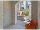 Charming outdoor patio area featuring an orange chair, a stone wall, and a view of the neighborhood at 1694 E Dogwood Ln, Gilbert, AZ 85295