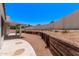 Landscaped backyard featuring retaining wall and covered patio at 17025 E De Anza Dr, Fountain Hills, AZ 85268