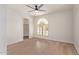 Bedroom with ceiling fan and natural light from arched window at 17025 E De Anza Dr, Fountain Hills, AZ 85268