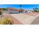 A lovely home featuring a spacious driveway, desert landscaping, and a charming tile roof at 17025 E De Anza Dr, Fountain Hills, AZ 85268