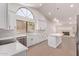 Open-concept kitchen featuring white cabinets, stainless steel appliances and large window at 17025 E De Anza Dr, Fountain Hills, AZ 85268