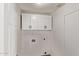 Clean, white laundry area with overhead cabinets and utility connections at 17025 E De Anza Dr, Fountain Hills, AZ 85268